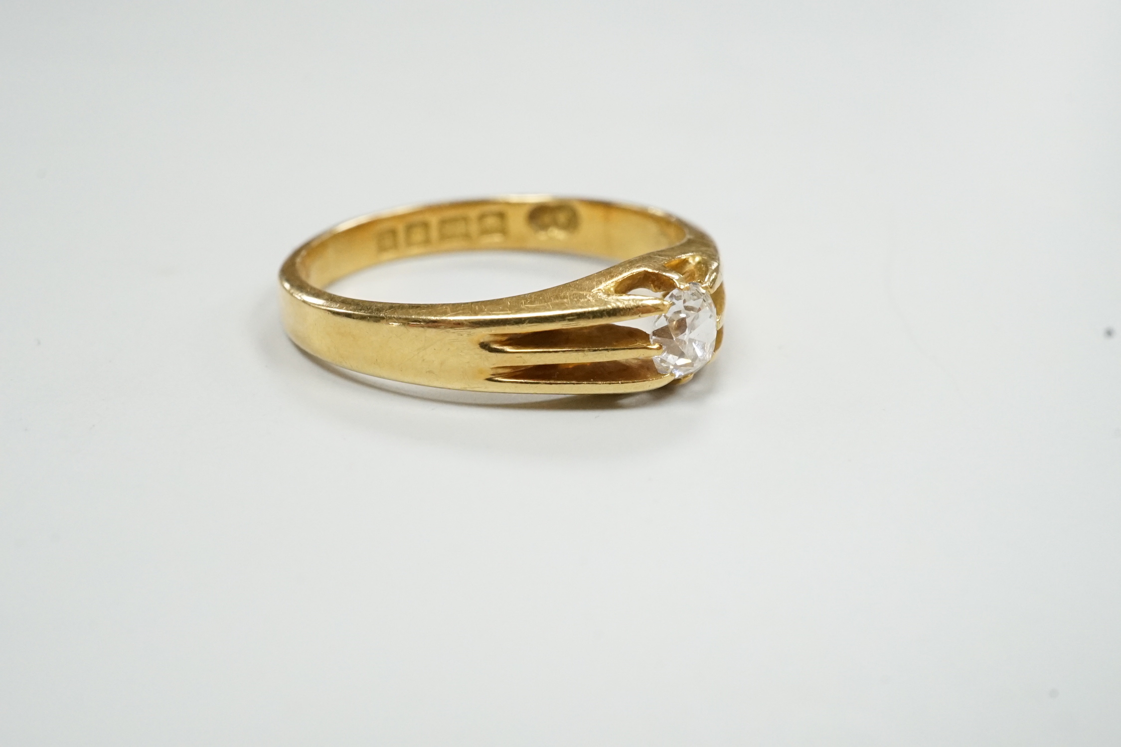 A George V 18ct gold and claw set solitaire diamond ring, size R, gross weight 5.1 grams.